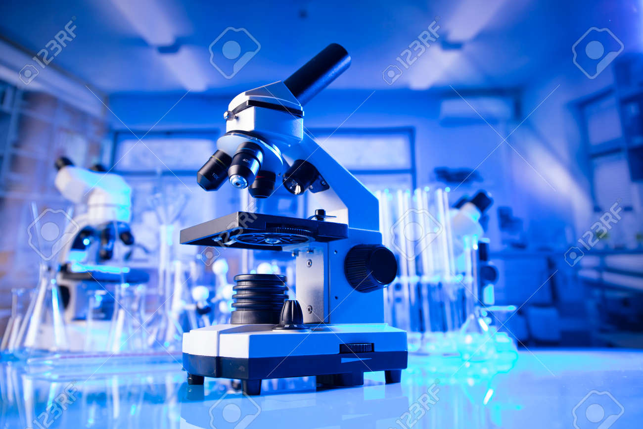 pandemic theme. Science research concerning fast tests and anti-vaccine. Microscope, beakers and test tubes in the scientific laboratory. - 169346784 pandemic theme. Science research concerning fast tests and anti-vaccine. Microscope, beakers and test tubes in the scientific laboratory. - 169346784