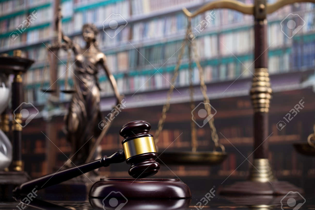 Law and justice concept. Gavel of the jugde, Themis sculpture and scale of justice in the court library. - 169346865 Law and justice concept. Gavel of the jugde, Themis sculpture and scale of justice in the court library. - 169346865