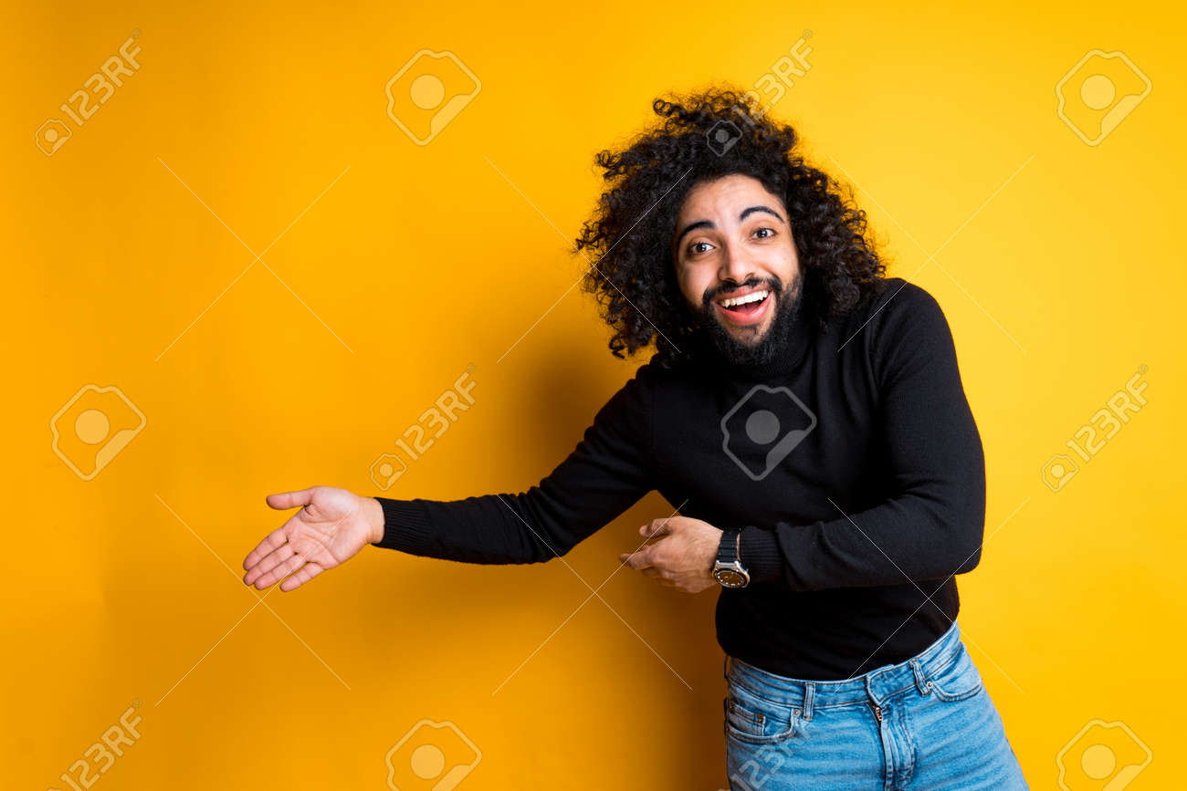 Handsome Egyptian In A Black Turtleneck Laughs And Joyfully Points His  Hands To The Side Stock Photo, Picture and Royalty Free Image. Image  166571164., image size:1300x867