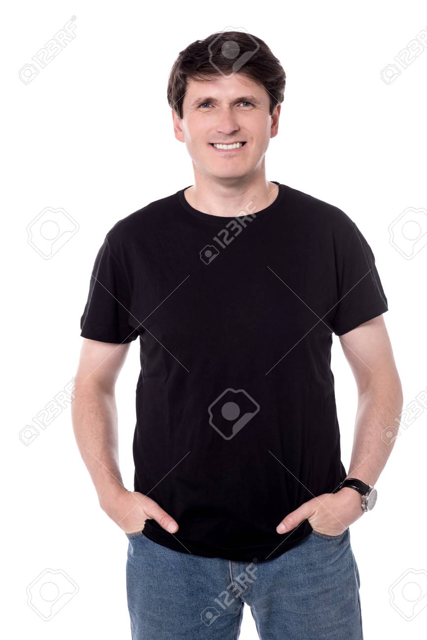 Smiling male with hands in pockets posing to camera. - 60379380 Smiling male with hands in pockets posing to camera. - 60379380