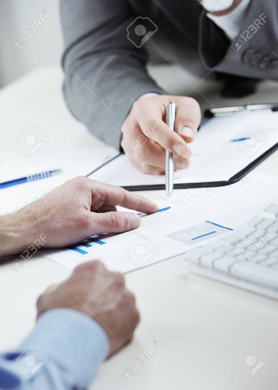 Cropped shot of business colleagues discussing together in an office - 22238373 Cropped shot of business colleagues discussing together in an office - 22238373