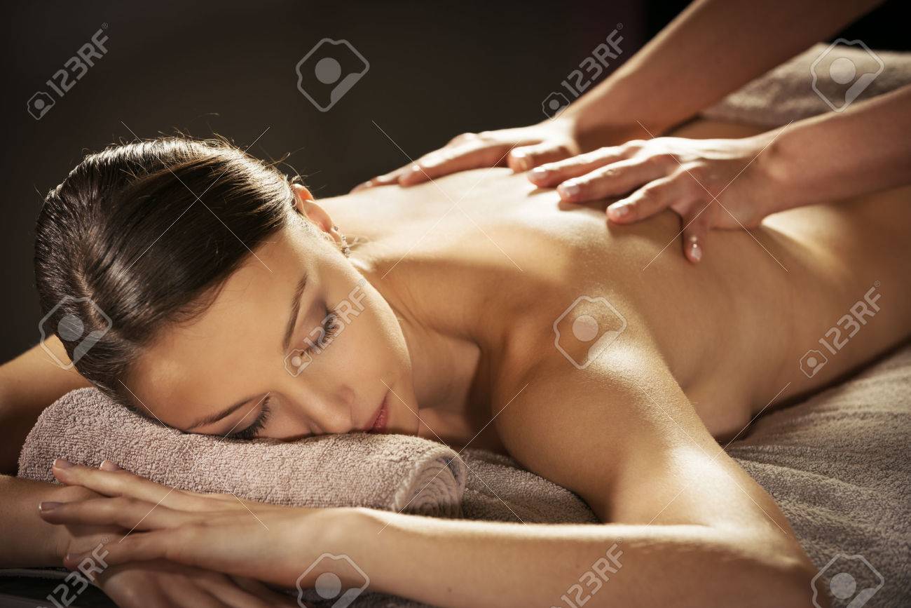 Beautiful Woman Receiving a Relaxing Back Massage at Spa. Stock