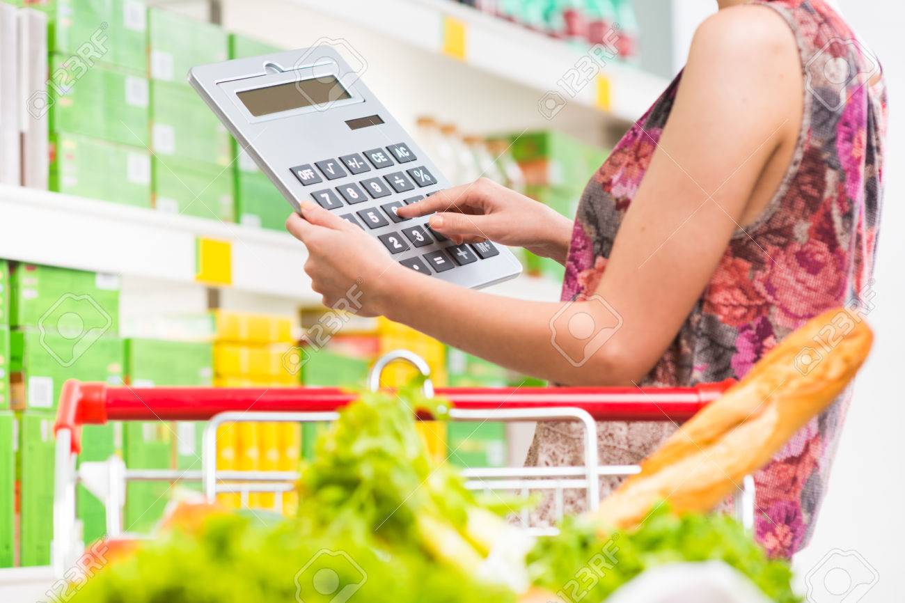 https://previews.123rf.com/images/stokkete/stokkete1410/stokkete141000434/32580399-woman-shopping-at-supermarket-with-shopping-cart-and-big-calculator-checking-prices.jpg