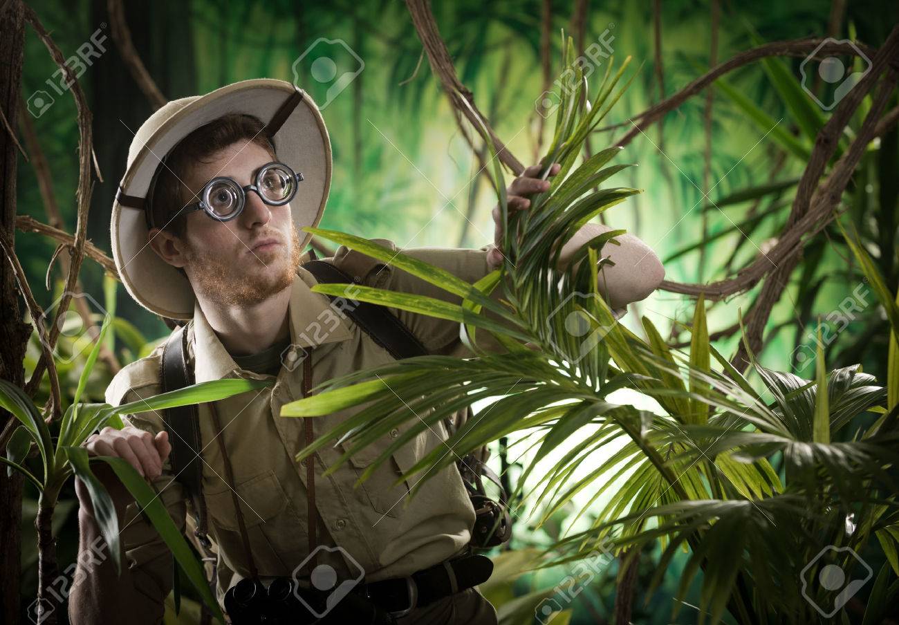 Young Explorer Guy Walking In The Rainforest Jungle With