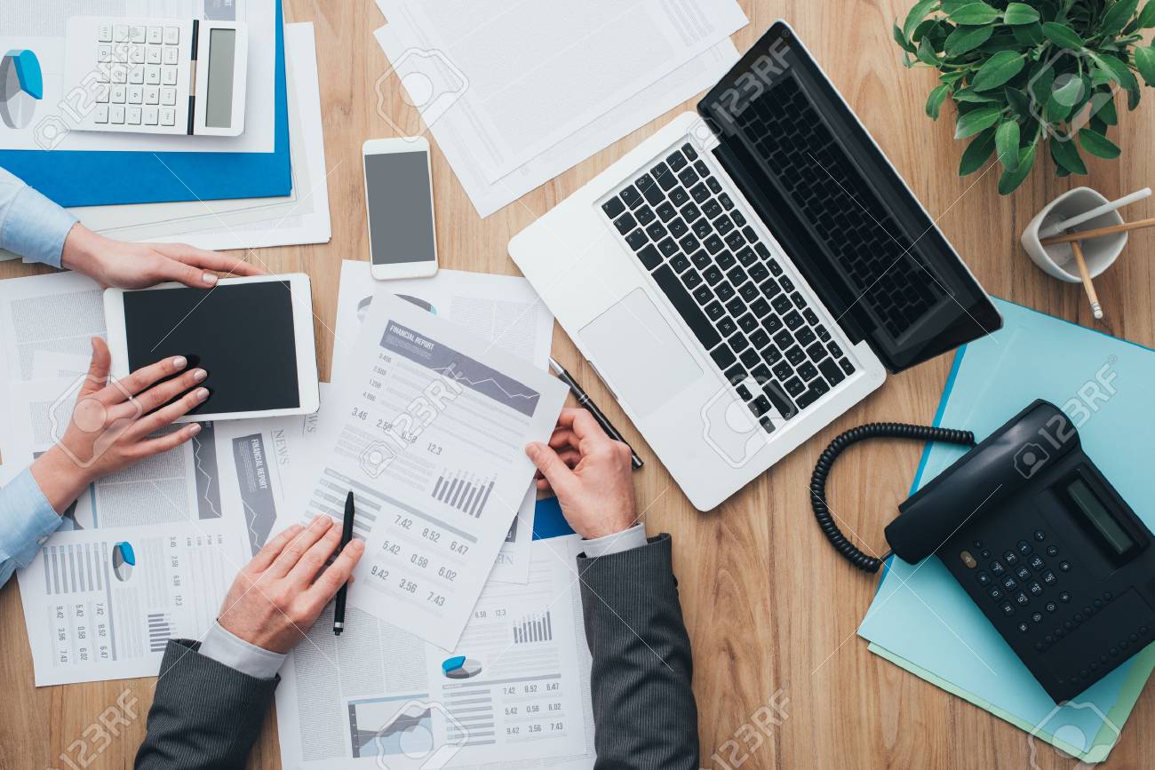 Business Team Working At Office Desk And Analyzing Financial Reports, Finance And Accounting Concept, Top View Stock Photo, Picture And Royalty Free Image. Image 67045141.