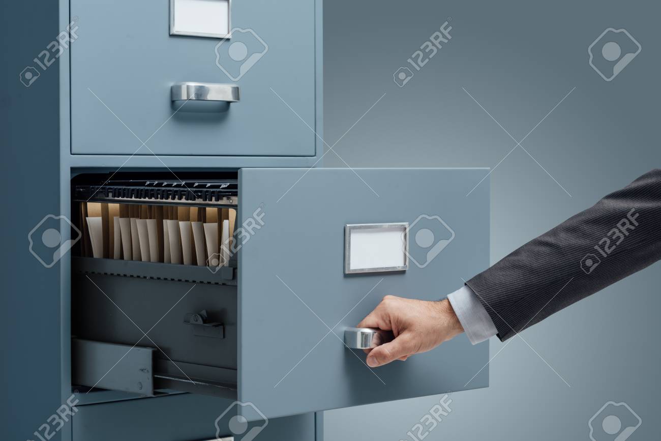 Office clerk searching files in a filing cabinet, data storage and administration concept - 88211712 Office clerk searching files in a filing cabinet, data storage and administration concept - 88211712