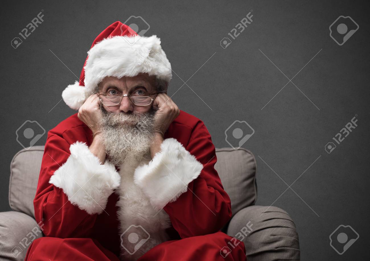 Santa Claus sitting on the armchair and waiting for Christmas, he is resting his head on his hands - 89097219 Santa Claus sitting on the armchair and waiting for Christmas, he is resting his head on his hands - 89097219