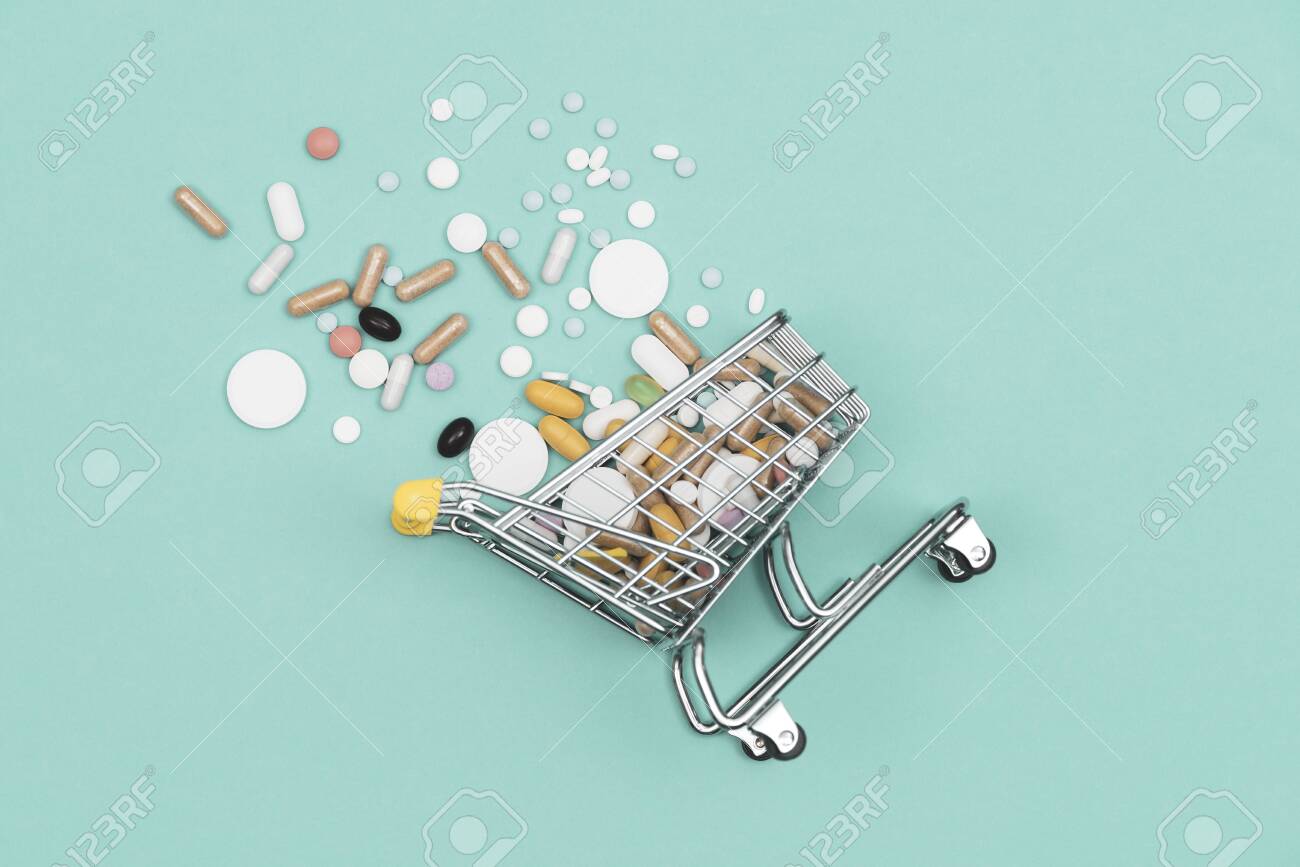 Miniature shopping cart filled with pills, tablets and capsules: pharmacy shopping, medicine and drug abuse concept - 121245408 Miniature shopping cart filled with pills, tablets and capsules: pharmacy shopping, medicine and drug abuse concept - 121245408