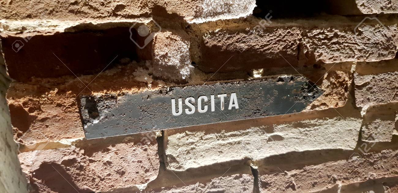 A rusty exit sign in a stone wall - 105981646 A rusty exit sign in a stone wall - 105981646