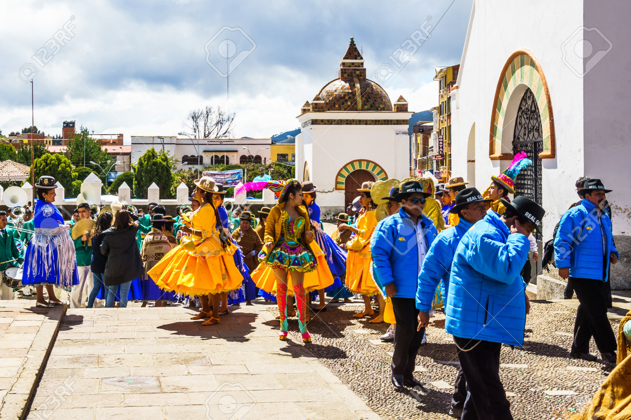 Cocacabana, Bolivia 30th April 2017: View on group of local people celebrating parade and playing drum and woman in dress dancing - 142308230 Cocacabana, Bolivia 30th April 2017: View on group of local people celebrating parade and playing drum and woman in dress dancing - 142308230