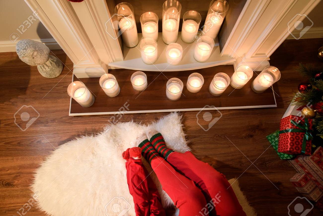 An Upper View On A Nice Fireplace With Elegant Candles And Two