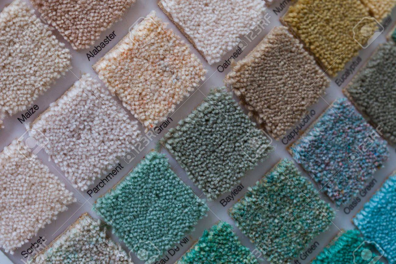 Colourful carpet display in a shop with square samples wall mounted in a variety of colours to plan your interior decor and renovation - 21338490 Colourful carpet display in a shop with square samples wall mounted in a variety of colours to plan your interior decor and renovation - 21338490
