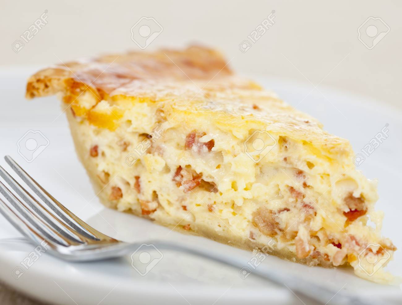 Fresh Baked Slice Of Quiche Lorraine On A Plate Stock Photo