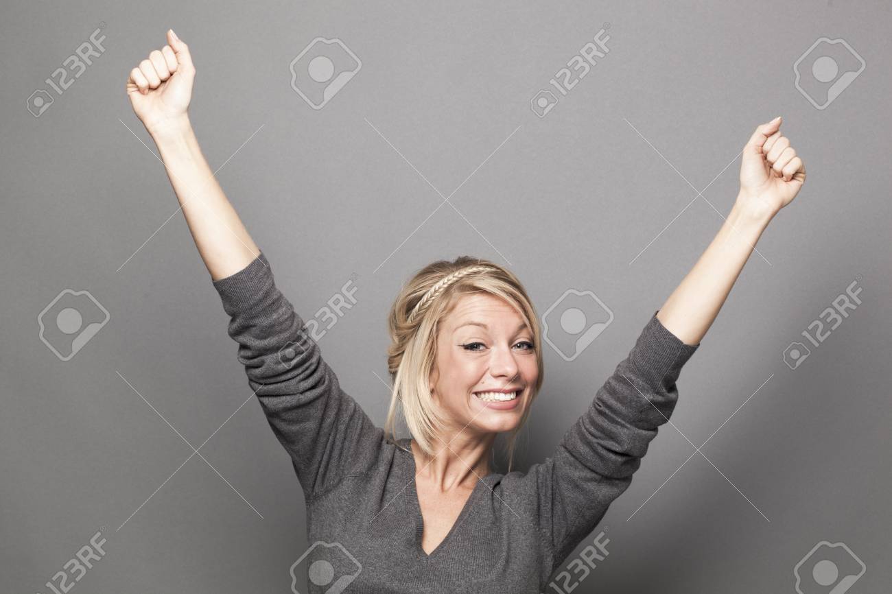success concept - ecstatic young blonde woman winning a competition with fun body language - 52422700 success concept - ecstatic young blonde woman winning a competition with fun body language - 52422700