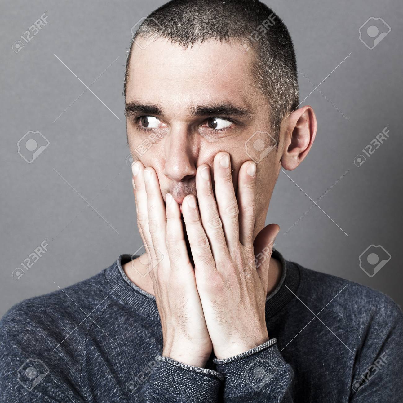 Portrait Of Fear Scared Young Man With Short Hair Hiding His