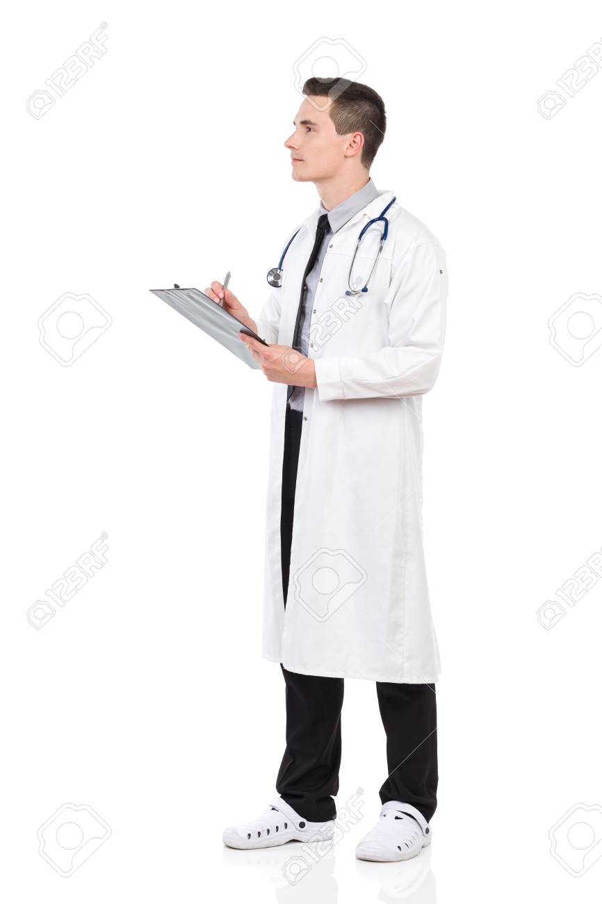 Focused Male Doctor In White Lab Coat Holding A Clipboard And Stock Photo Picture And Royalty Free Image Image 56750011