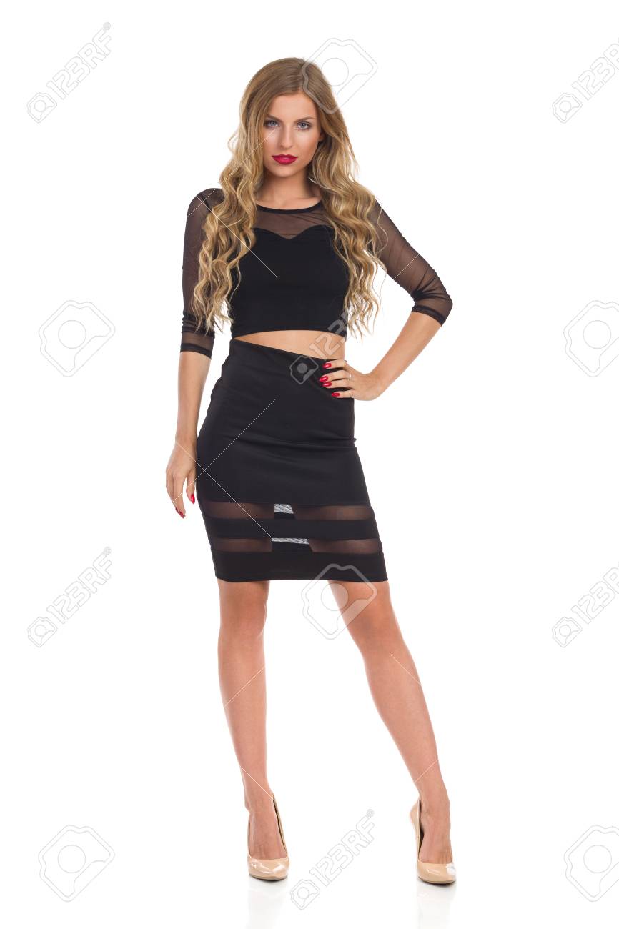 Schöne Blonde Junge Frau Im Schwarzen Kleid Und Beige High Attraktive Frau posiert in kurzen schwarzen Kleid und high