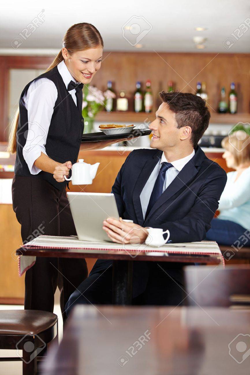 Female Waiter Serving Businessman In Coffee Shop A Pot Of Coffee - Female Waiter Serving Businessman In Coffee Shop A Pot Of Coffee Stockphoto female waiter serving businessman in coffee shop a pot of coffee - female waiter serving businessman in coffee shop a pot of coffee stockphoto