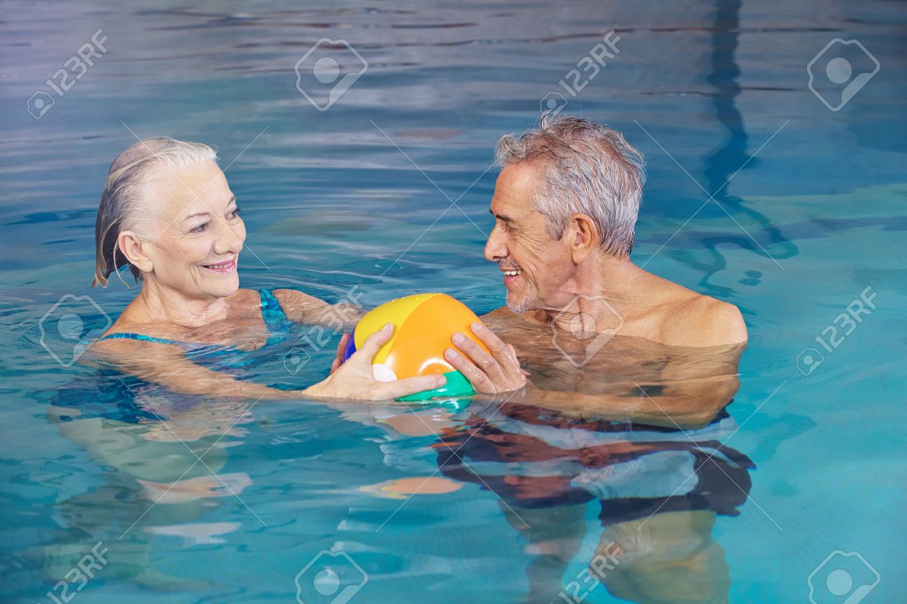 Pool Water With Beach Ball happy senior couple playing water ball with beach ball in swimming Pool Water With Beach Ball happy senior couple playing water ball with beach ball in swimming