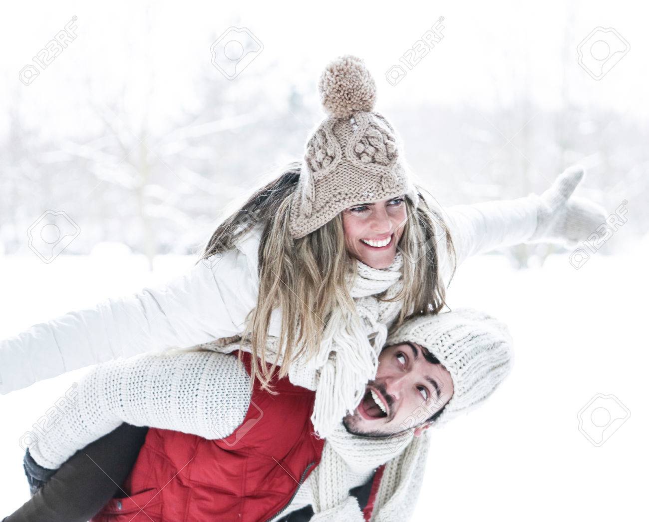 Happy man carrying smiling woman for piggyback ride in winter - 44899357 Happy man carrying smiling woman for piggyback ride in winter - 44899357