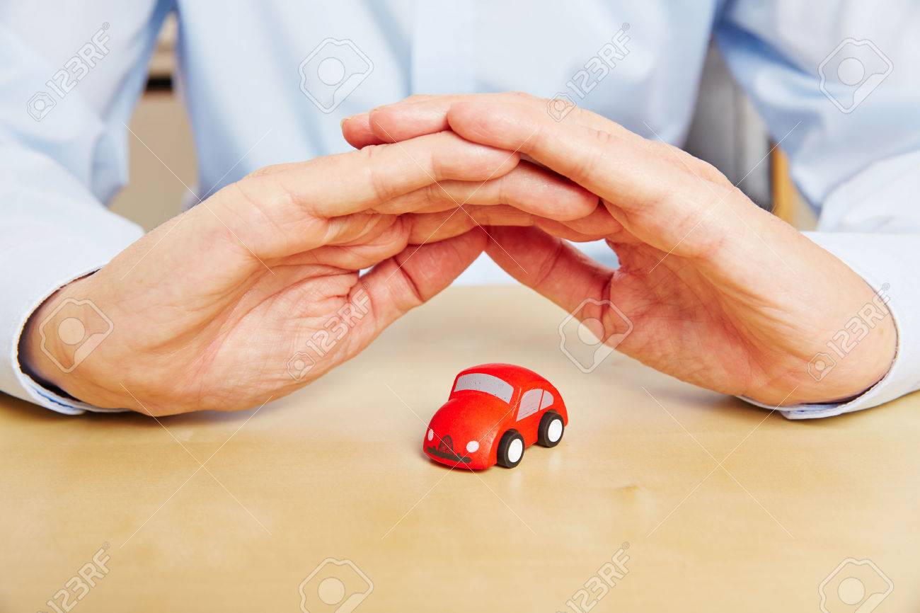 Car insurance with hands over red vehicle as a symbol - 53562628 Car insurance with hands over red vehicle as a symbol - 53562628