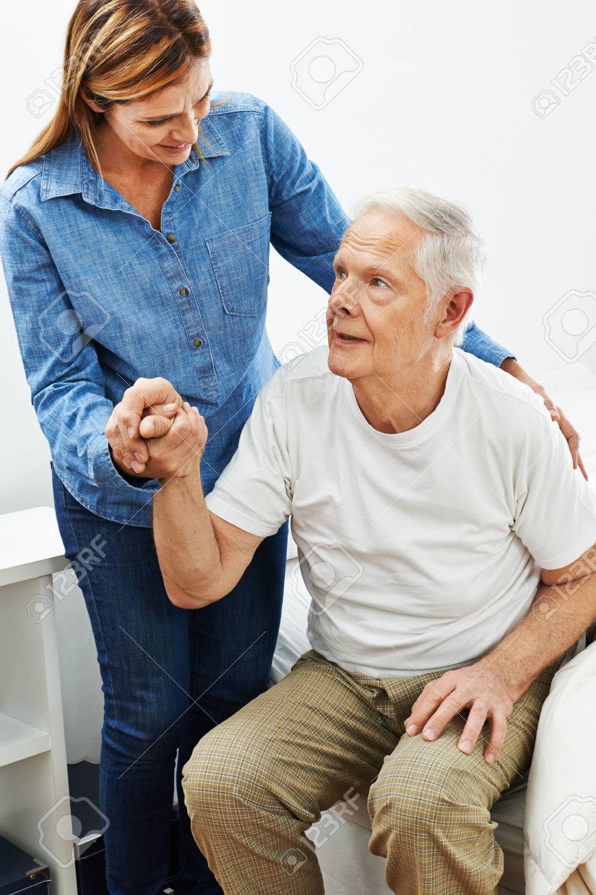 Daughter Helping Old Senior Man Getting Up From Bed Stock Photo, Picture  and Royalty Free Image. Image 59220901.