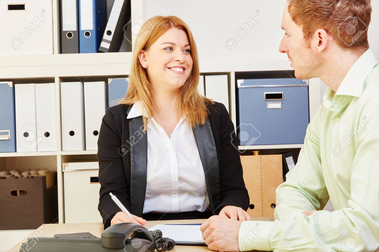 woman giving financial advice to a man for a credit1 stock photo