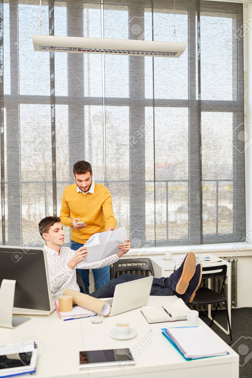 architect and consulting manager looking at architectural drawing