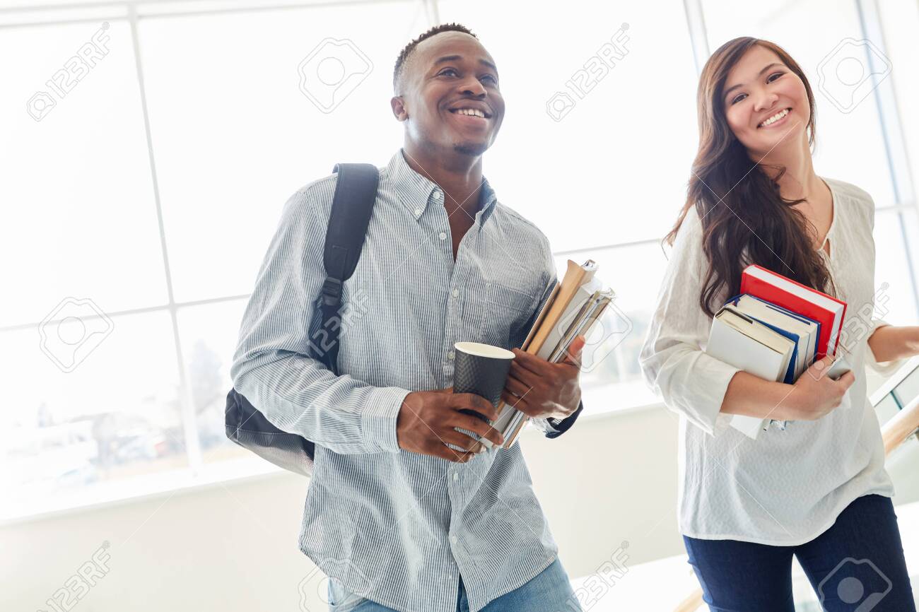 Happy students as a interracial couple in university - 127779939 Happy students as a interracial couple in university - 127779939