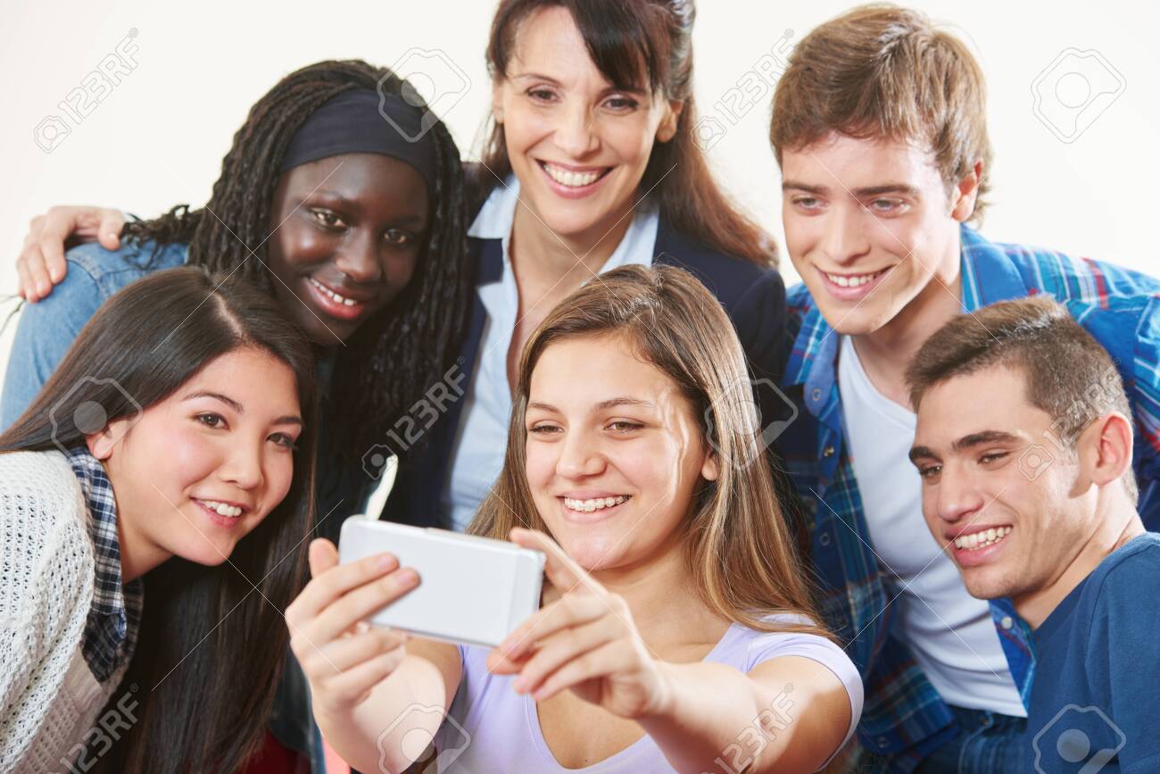 Laughing group of students takes a selfie with teacher together - 138550874 Laughing group of students takes a selfie with teacher together - 138550874