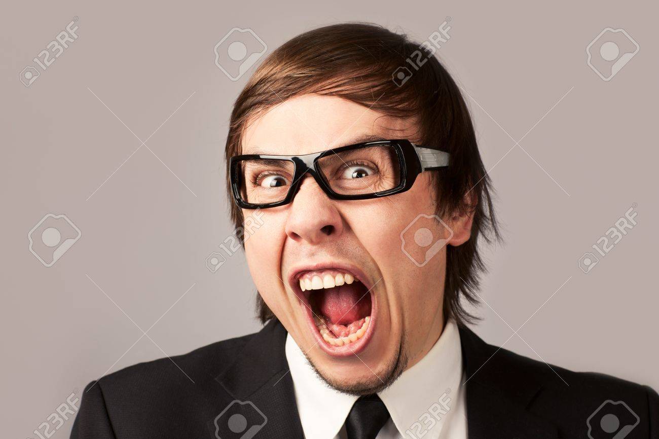 Close-up photo of screaming businessman, on a gray background - 12905288 Close-up photo of screaming businessman, on a gray background - 12905288