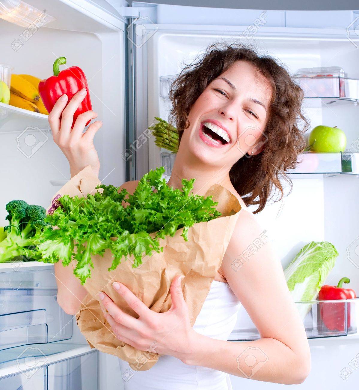 Beautiful Young Woman near the Refrigerator with healthy food - 13064625 Beautiful Young Woman near the Refrigerator with healthy food - 13064625