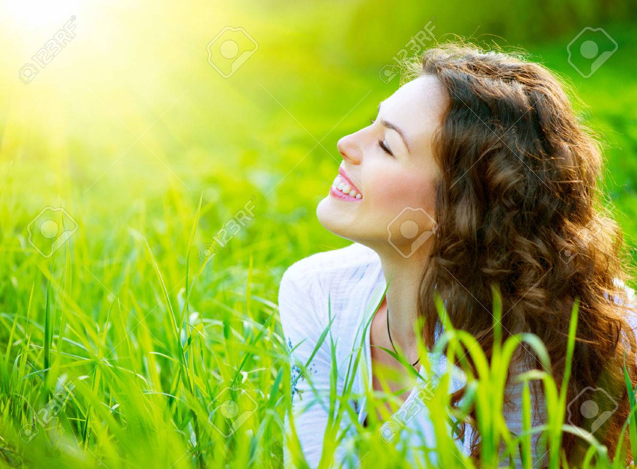 Beautiful Spring Young Woman Outdoors Enjoying Nature - 25594201 Beautiful Spring Young Woman Outdoors Enjoying Nature - 25594201