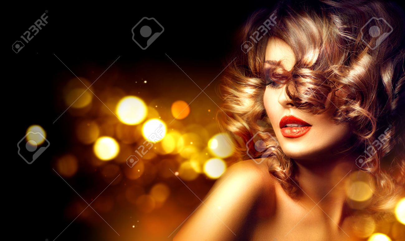 Beauty woman with beautiful makeup and curly hairstyle over holiday dark background - 51203099 Beauty woman with beautiful makeup and curly hairstyle over holiday dark background - 51203099
