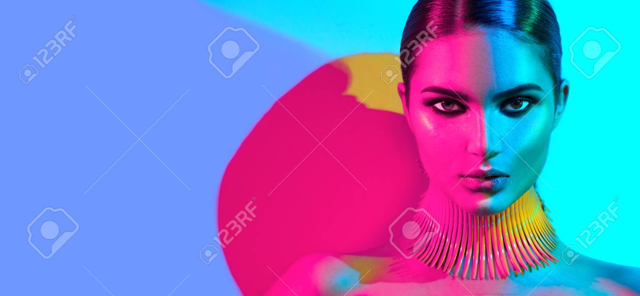 Fashion model woman in colorful bright lights posing. Portrait of beautiful girl with trendy makeup - 88170751 Fashion model woman in colorful bright lights posing. Portrait of beautiful girl with trendy makeup - 88170751