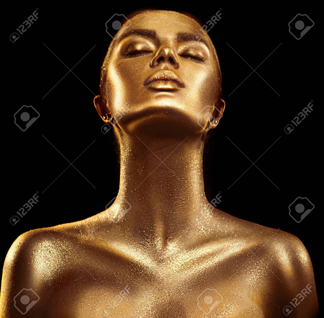 Fashion art golden skin woman portrait closeup. Gold, jewelry, accessories. Model girl with golden glamour shiny makeup - 98589011 Fashion art golden skin woman portrait closeup. Gold, jewelry, accessories. Model girl with golden glamour shiny makeup - 98589011