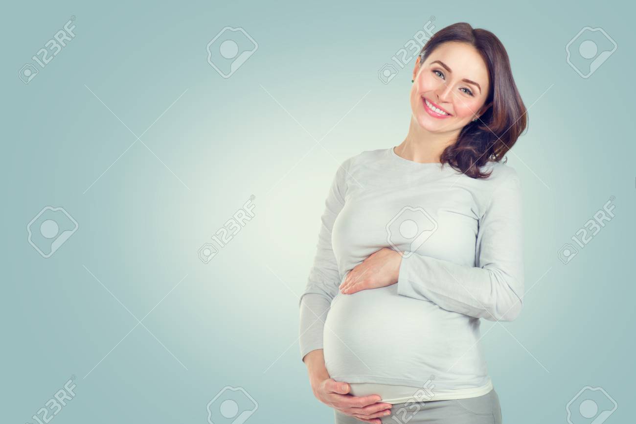 Pregnant happy woman touching her belly. Pregnant middle aged woman portrait. Healthy pregnancy concept - 100150815 Pregnant happy woman touching her belly. Pregnant middle aged woman portrait. Healthy pregnancy concept - 100150815