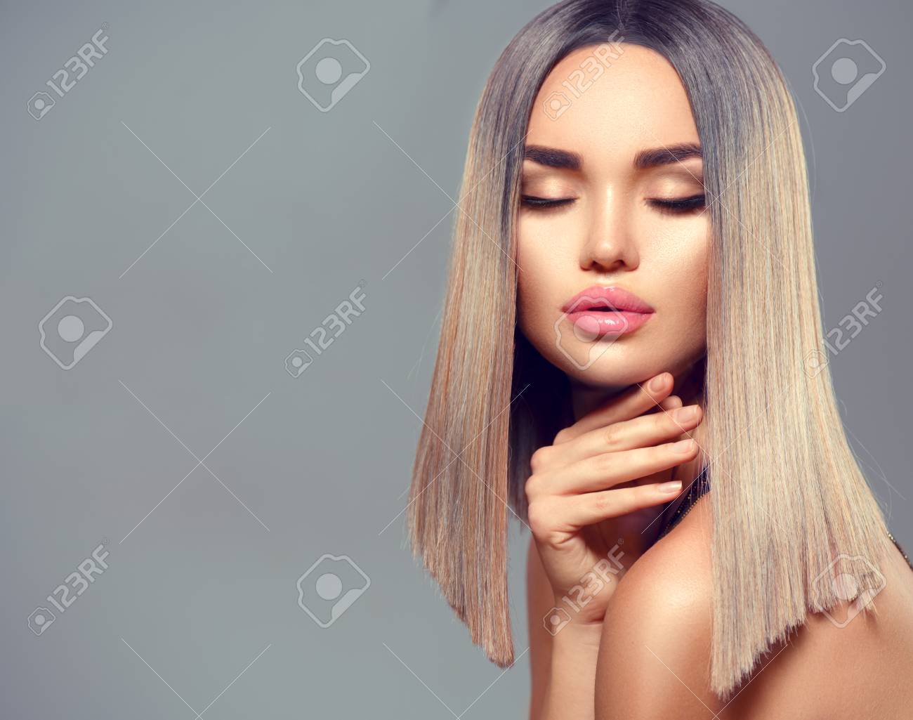 Fashion hairstyle. Ombre dyed hair. Beauty Model girl with perfect healthy hair and beautiful makeup posing in studio, young woman portrait on grey background - 108169014 Fashion hairstyle. Ombre dyed hair. Beauty Model girl with perfect healthy hair and beautiful makeup posing in studio, young woman portrait on grey background - 108169014