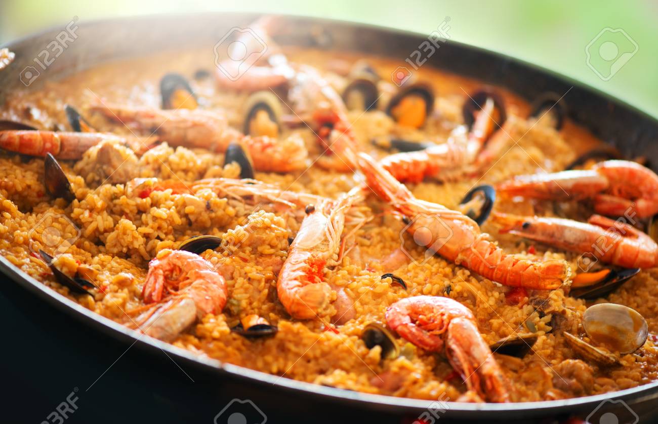 Paella. Traditional spanish food, seafood paella in the fry pan with mussels, king prawns, langoustine and squids. Cooking paella outside - 112655218 Paella. Traditional spanish food, seafood paella in the fry pan with mussels, king prawns, langoustine and squids. Cooking paella outside - 112655218