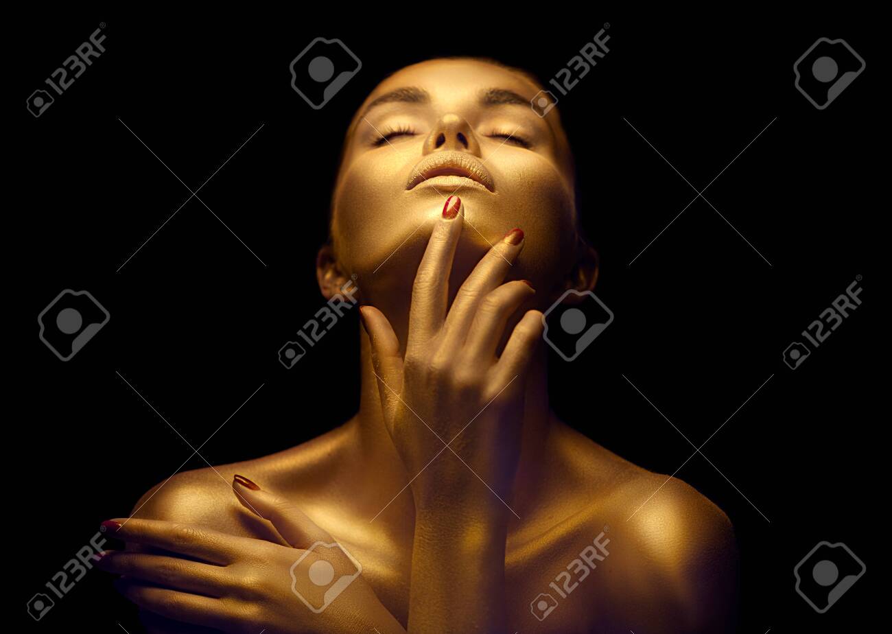 Beauty woman with golden skin. Fashion art portrait closeup. Model girl with shiny golden professional makeup. Gold jewellery - 125524183 Beauty woman with golden skin. Fashion art portrait closeup. Model girl with shiny golden professional makeup. Gold jewellery - 125524183
