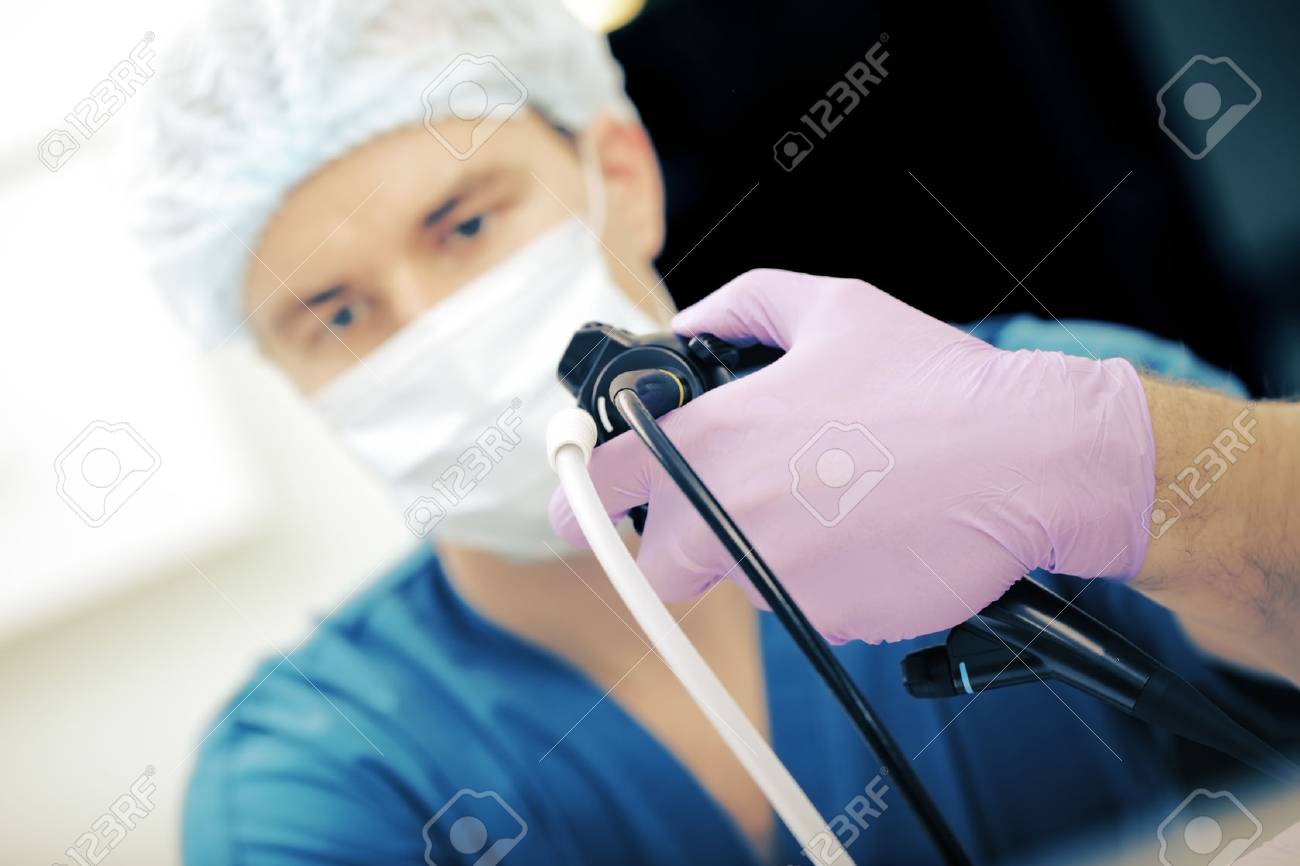 Male doctor conducts endoscopic examination. - 56344819 Male doctor conducts endoscopic examination. - 56344819