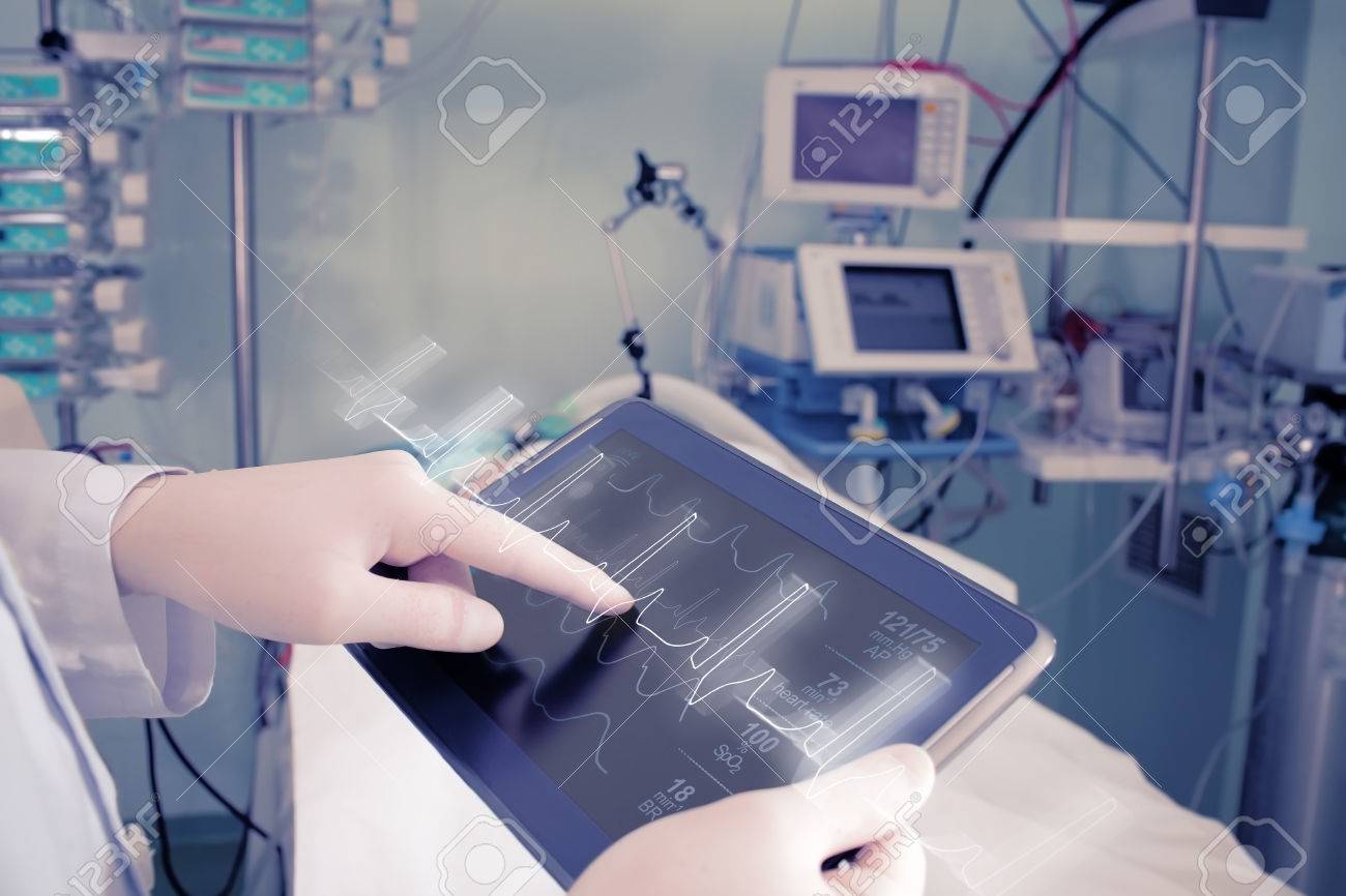 Doctor with advanced equipment in hospital ward. - 57952399 Doctor with advanced equipment in hospital ward. - 57952399