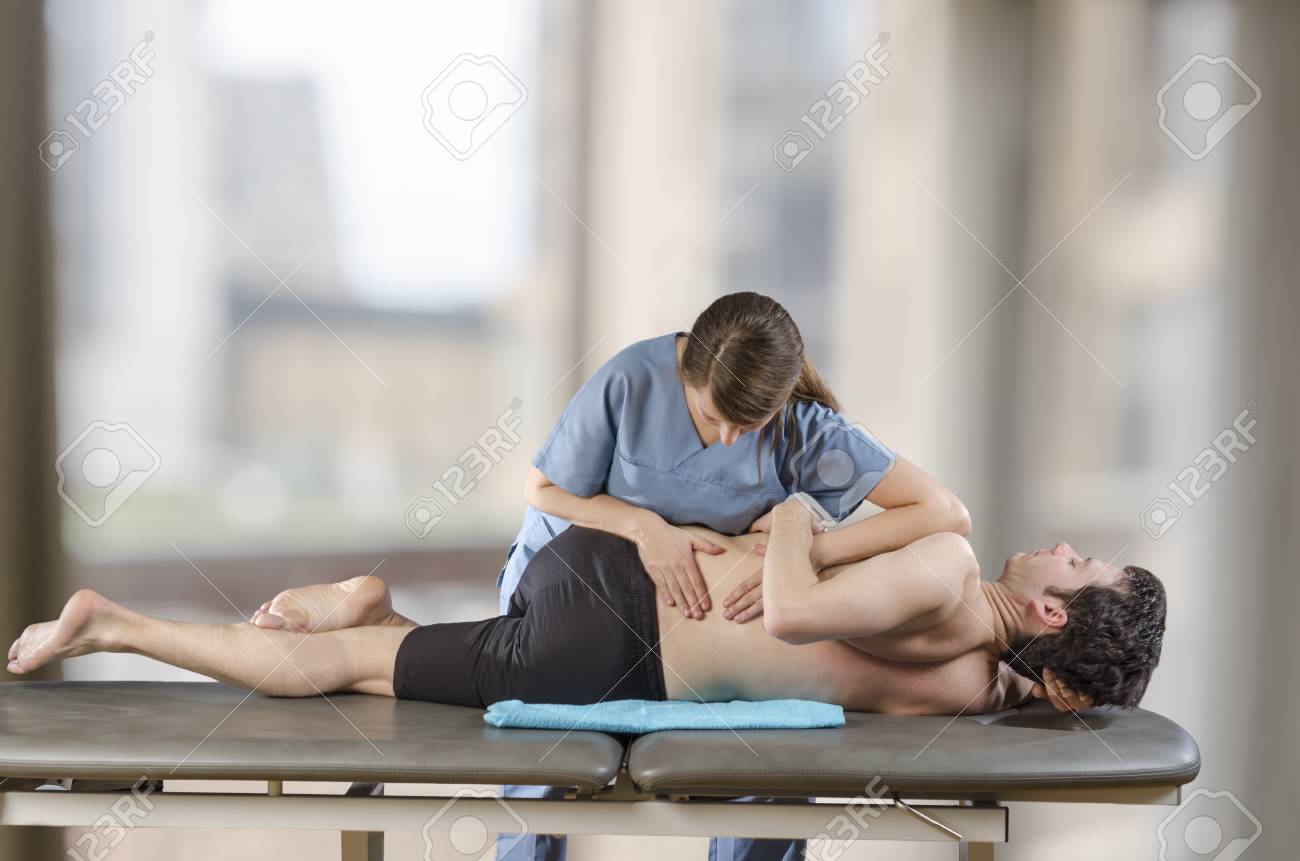 Physiotherapist doing manipulation to man patient. Osteopathy. - 96812293 Physiotherapist doing manipulation to man patient. Osteopathy. - 96812293