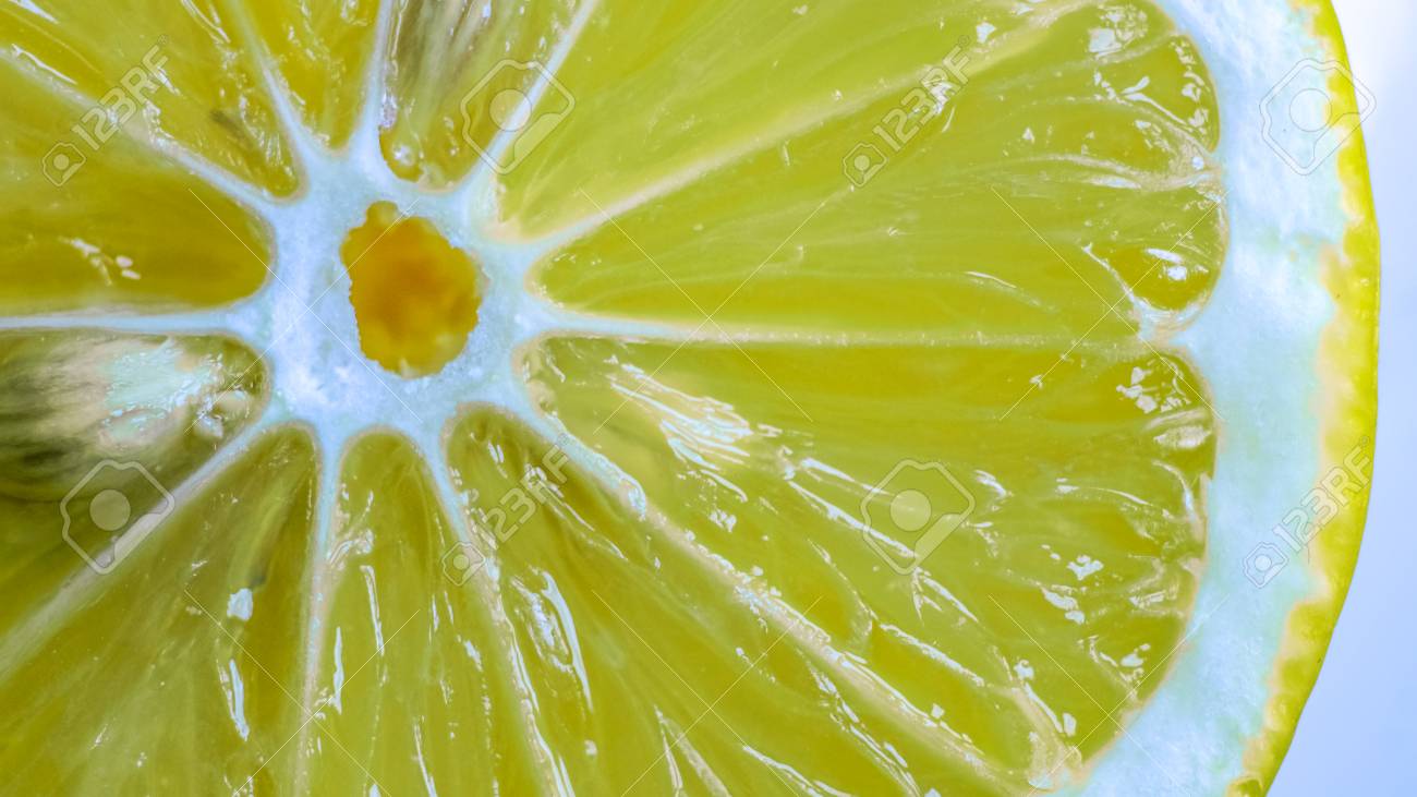 センター 皮膚や内部にいくつかの小さな象牙種に斜めの白い線に白い円で明るい黄色有機甘いジューシーなレモン スライス 新鮮な柑橘類の小葉のテクスチャ の写真素材 画像素材 Image