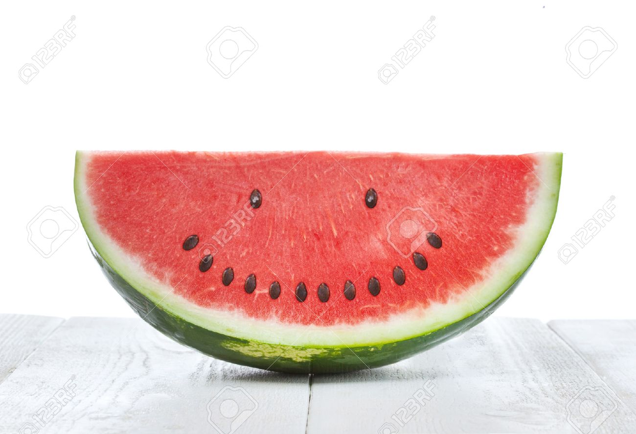 Slice of watermelon with seeds that make a smiling face - 41127351 Slice of watermelon with seeds that make a smiling face - 41127351