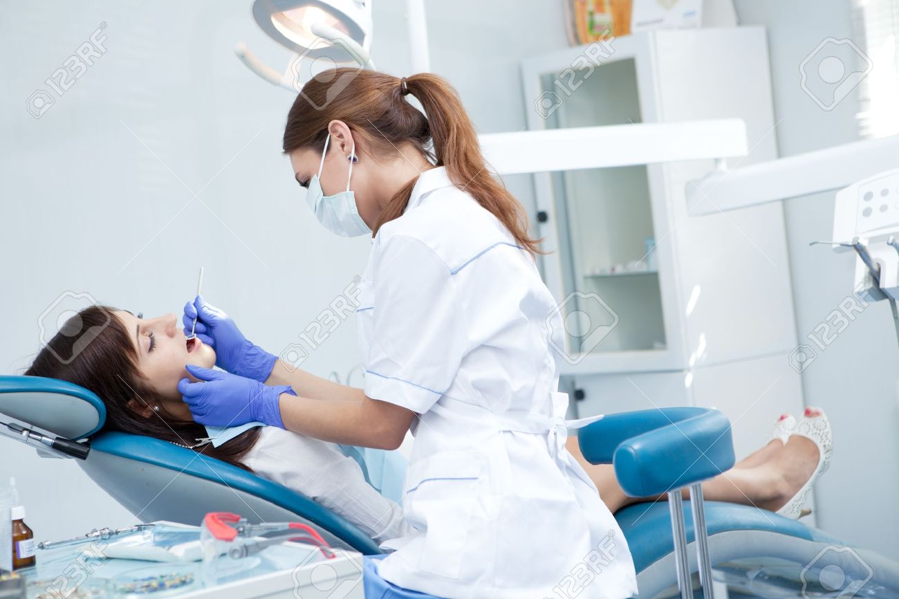 http://previews.123rf.com/images/supernam/supernam1206/supernam120600220/14202963-woman-dentist-working-Stock-Photo-patient.jpg