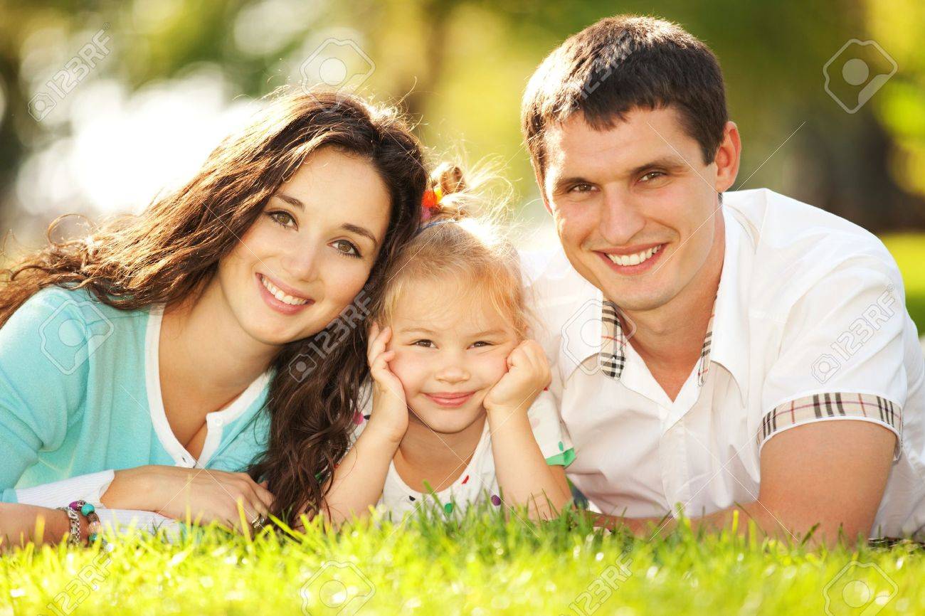 Happy Mother, Father And Daughter In The Park Stock Photo, Picture ...