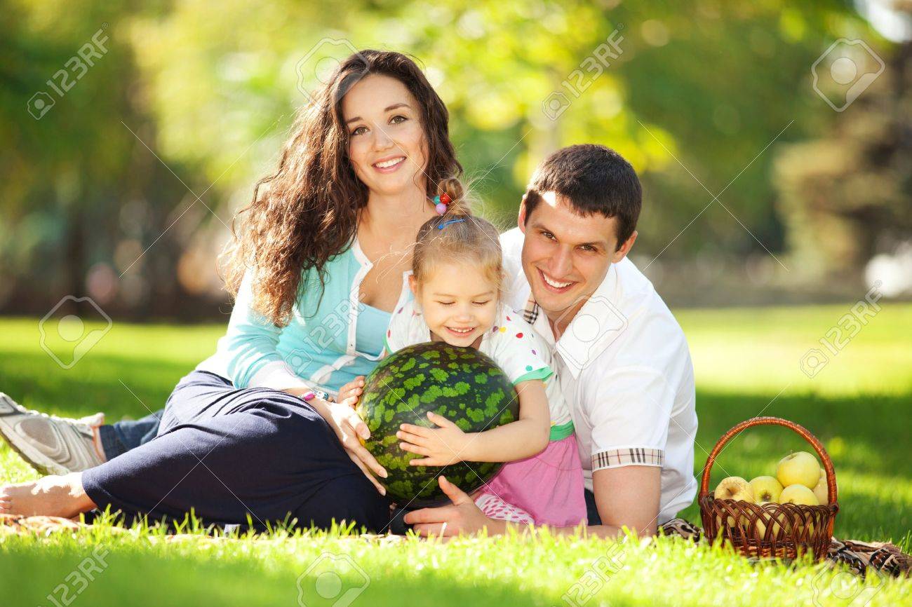 Happy family having a picnic in the green garden - 16694585 Happy family having a picnic in the green garden - 16694585