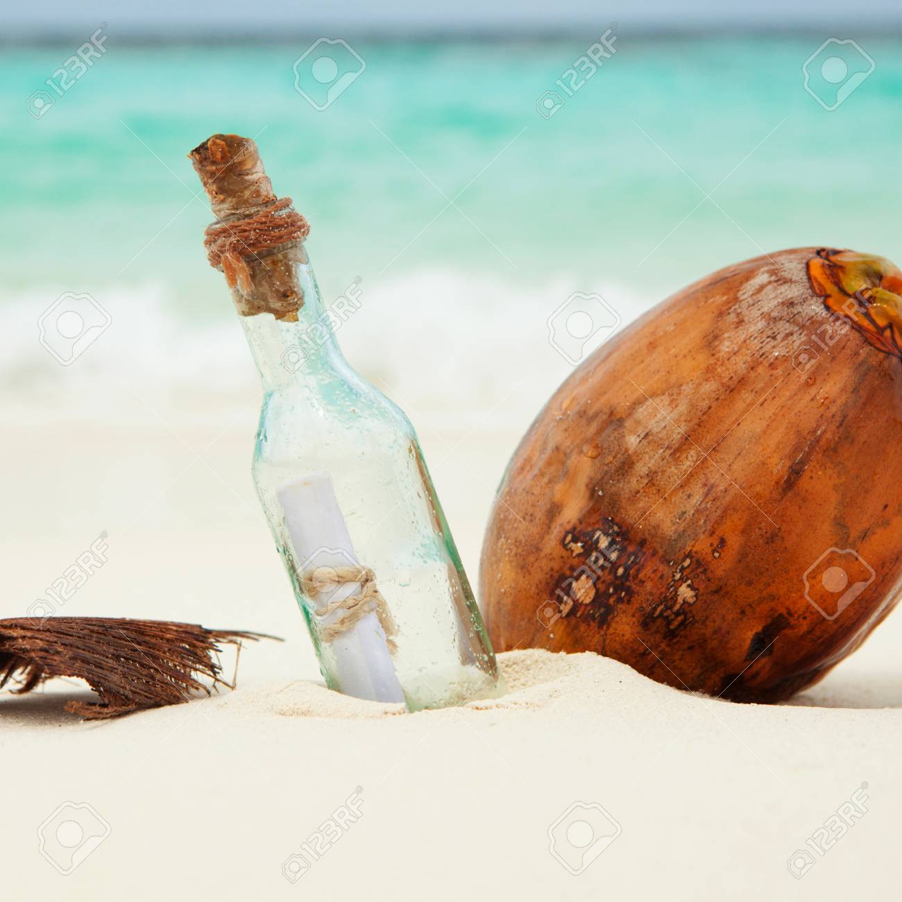 a letter in a bottle and a coconut on the beach stock photo picture letter in a bottle