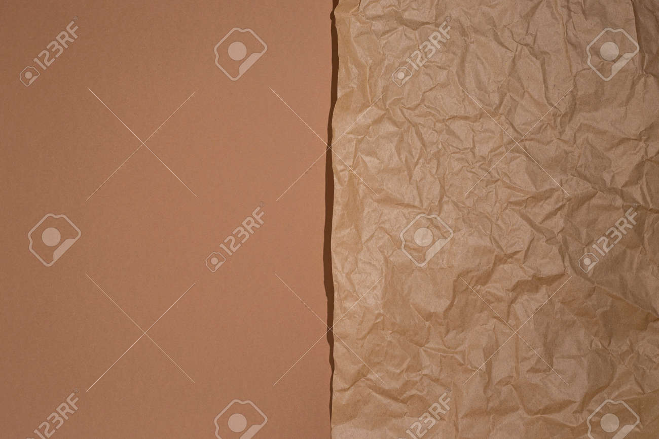 Crumpled craft paper on a brown cardboard background. - 171756560 Crumpled craft paper on a brown cardboard background. - 171756560